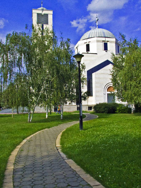 istock Tiled path in the park leads to the church 1059116016