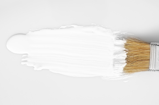 White paint brush stroke on white background. Top view point.