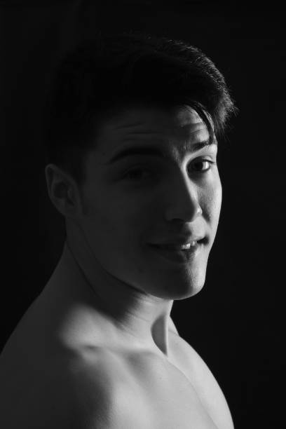 istock portrait of a young man on black background 1059120978