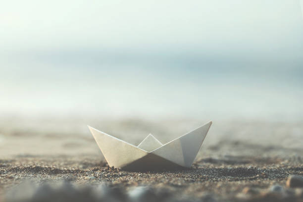 istock little minimal paper boat in the beach 1059121048