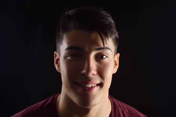 istock portrait of a young man on black background 1059121134