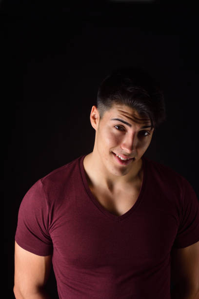 istock portrait of a young man on black background 1059121142