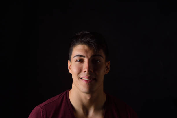 istock portrait of a young man on black background 1059121144