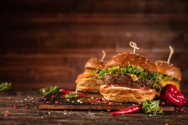 istock Delicious hamburger with fries, served on wood 1059121396