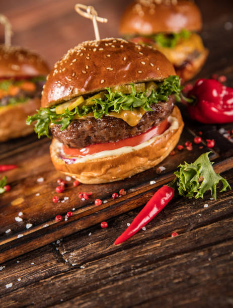 istock Delicious hamburger with fries, served on wood 1059121428
