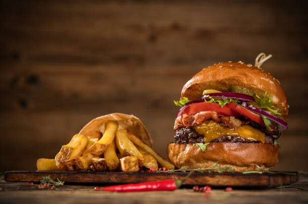 istock Delicious hamburger with fries, served on wood 1059121452