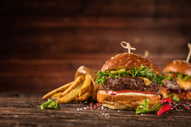 istock Delicious hamburger with fries, served on wood 1059121478