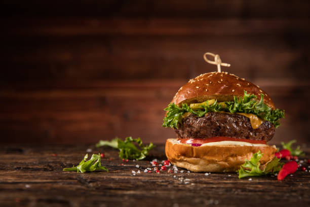 delicious hamburger, served on wood. - take out food fast food vertical tomato imagens e fotografias de stock