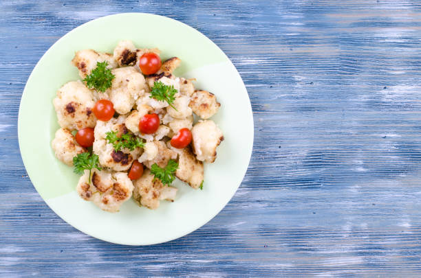 istock Dietary dish of cauliflower with tomatoes 1059121950