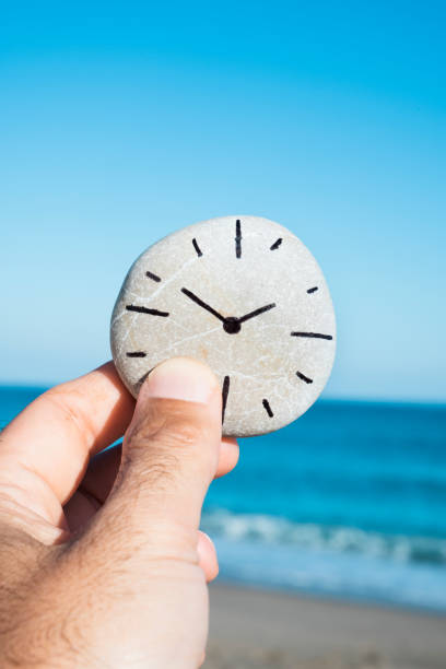istock man and a stone with a clock drawn in it 1059122100