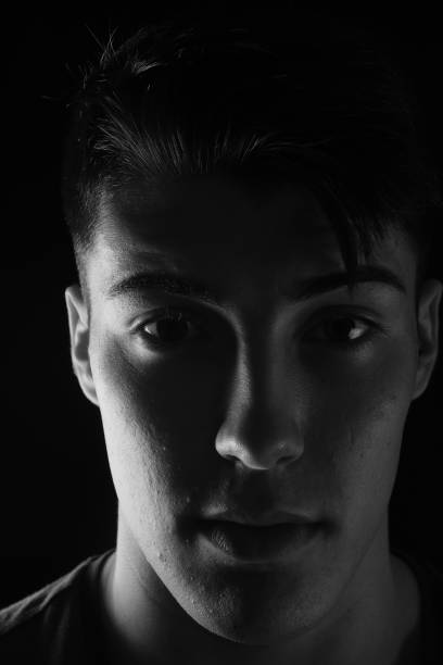 istock portrait of a young man on black background 1059125460