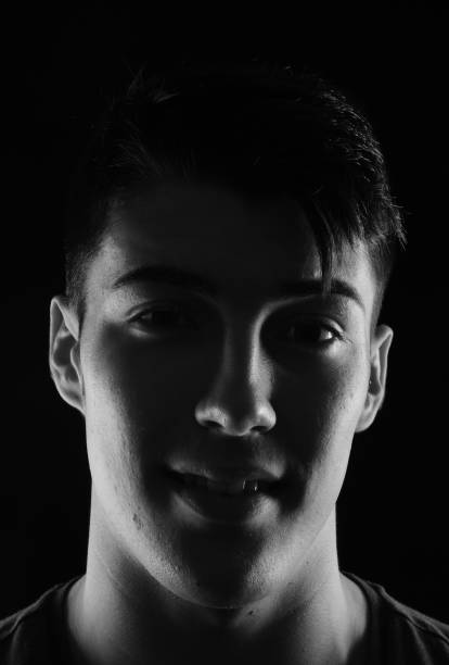 istock portrait of a young man on black background 1059125464