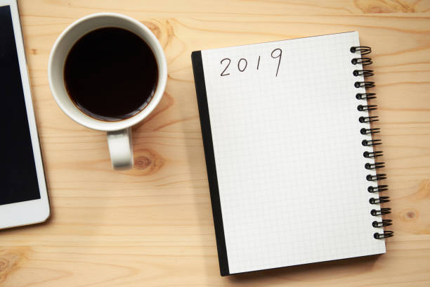 istock A cup of coffee and a notebook put on a wooden table 1059125504