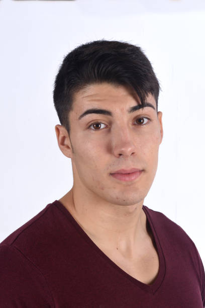istock portrait of a young man on black background 1059125538