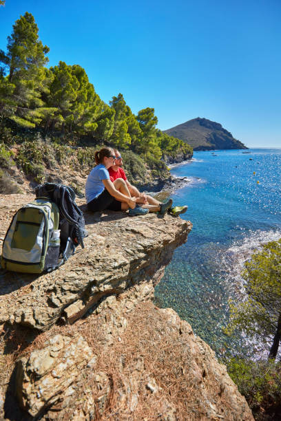 istock Relaxed couple resting next to the Mediterranean coast looking at view 1059127580