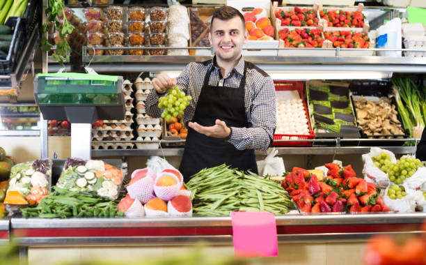istock Man seller is weighing grapes 1059127796