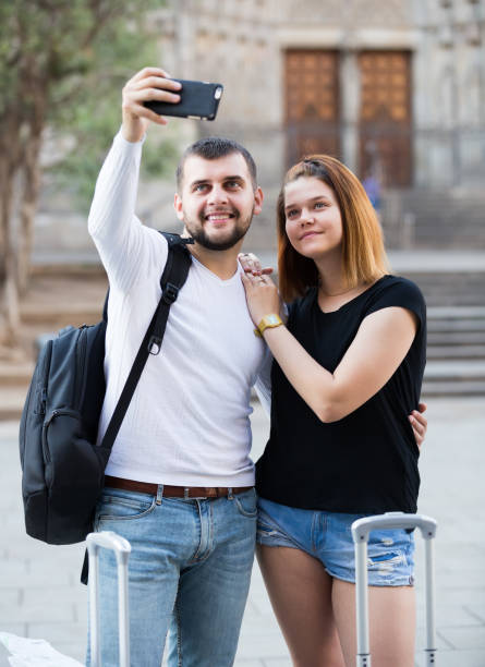 istock young female and male taking selfie 1059128802