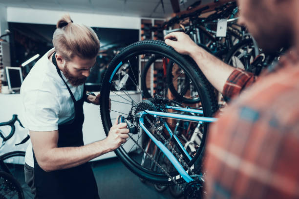 Professional Bike Repairman Fix Cycle in Workshop stock photo