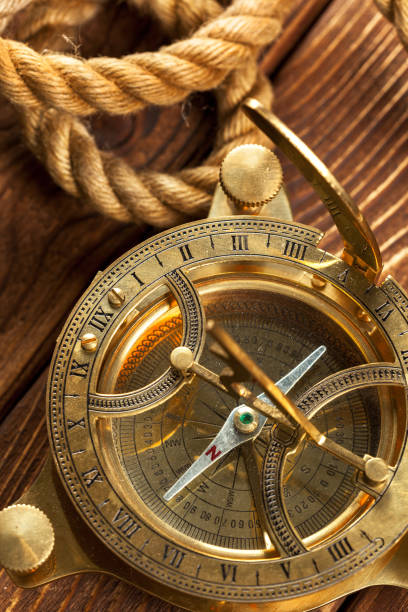istock Compass and rope on wooden table. close up 1059132500