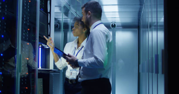istock Coworking IT specialists in data center room 1059137230