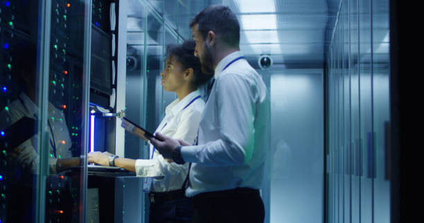 istock Coworking IT specialists in data center room 1059137234