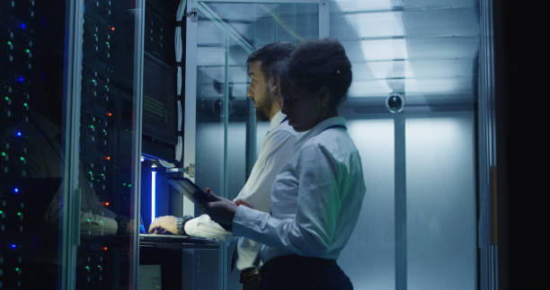 istock Contemporary IT engineers wearing VR glasses in data center 1059137284