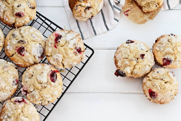 Fresh cranberry muffins cooling on a bakers rack