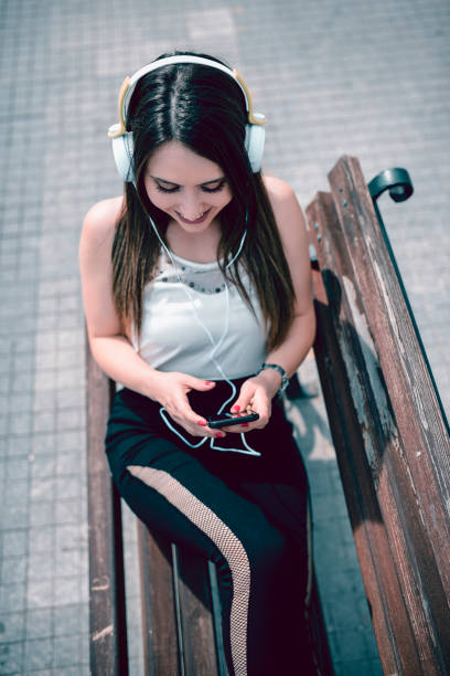 istock Seductive Girl Making A Video Call Whole Sitting On A Bench 1059143754
