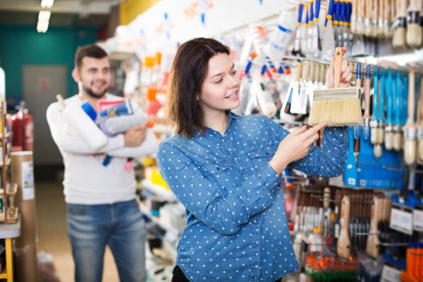 istock Couple choosing brush for house decoration 1059145246
