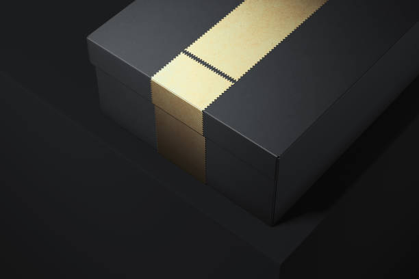 istock Black cardboard box with golden ribbon on black background. 3d rendering. 1059147198