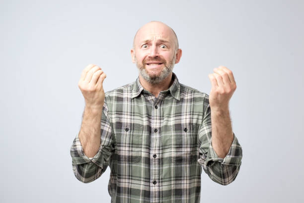 istock Studio shot of excited over-emotive mature man pulling hands towards camera and arguing or showing regret 1059149916