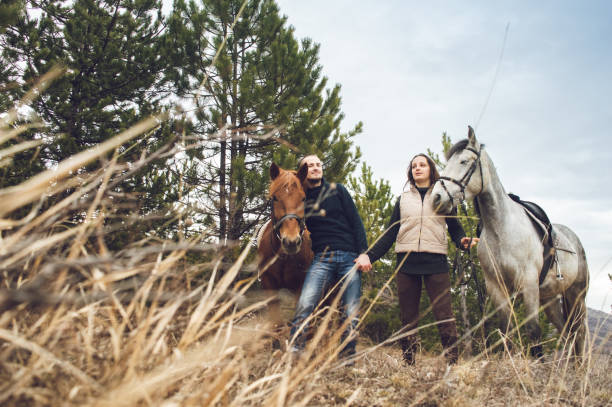 istock Young couple with horses 1059150196
