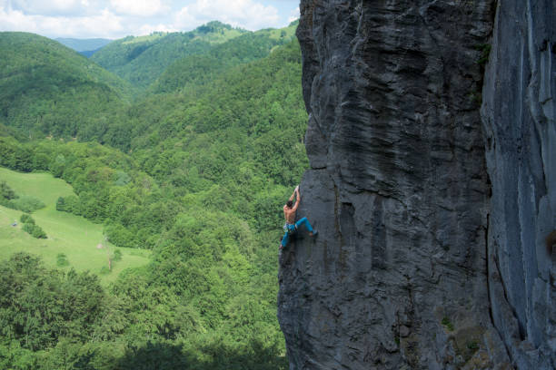 istock Man climbing a steep rock face 1059151758