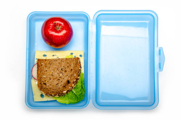 istock blue lunch box with bread and apple on white background, isolated 1059156396