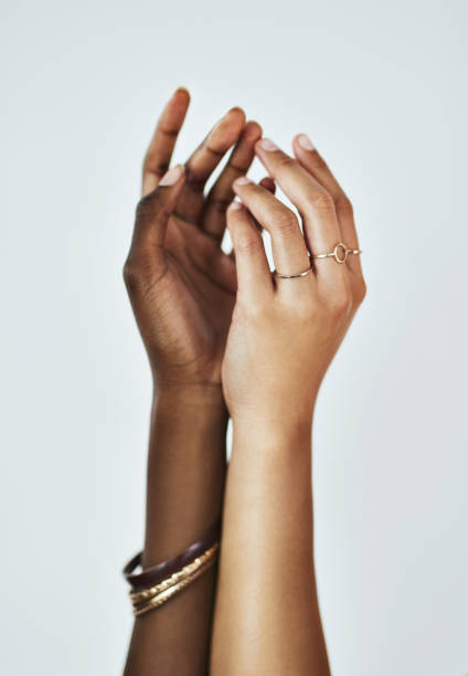Feel it to believe it Cropped studio shot of two women touching hands against a gray background melanin photos stock pictures, royalty-free photos & images