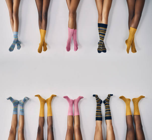 All kinds of socks to suit all kinds of feet Cropped studio shot of a group of women’s legs in a row wearing socks sock photos stock pictures, royalty-free photos & images