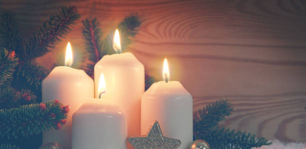 istock Four burning Advent candles and white snow. 1059158742