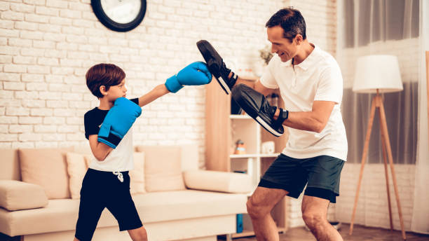 little boy in boxing gloves and man in apartment. - healthy lifestyle men boxing dumbbell imagens e fotografias de stock