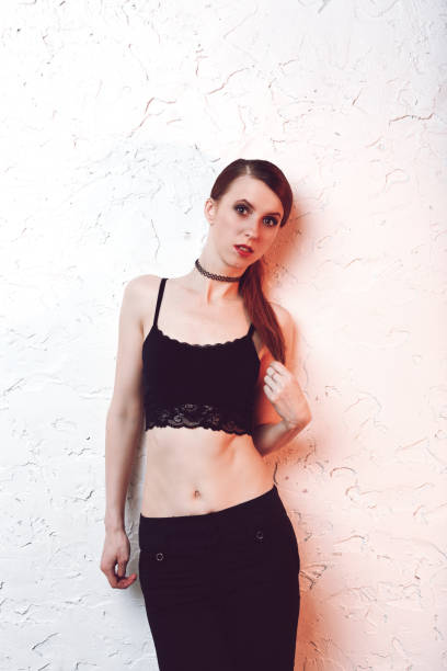 istock Redhead model woman standing and posing on white wall 1059162710