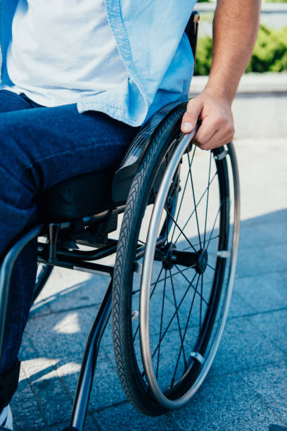 istock cropped image of man using wheelchair on street 1059163304