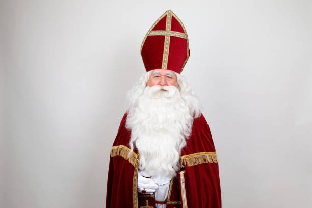 istock Saint Nicholas with mitre in red dress on white 1059163516