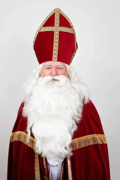 Saint Nicholas looks at you with a smile on white