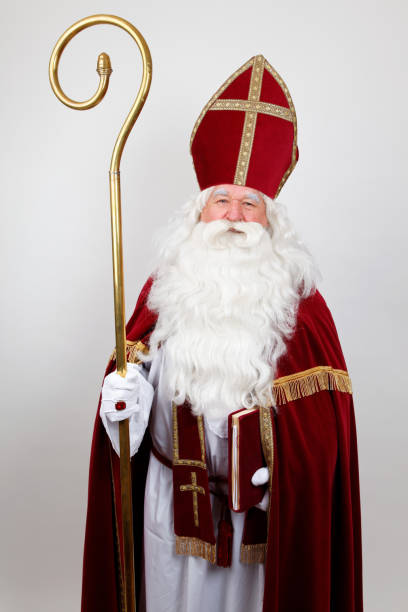 istock Saint Nicholas with staff red dress and mitre 1059163538