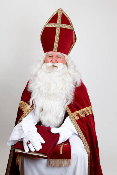 istock Saint Nicholas is sitting with his big book and mitre 1059163570