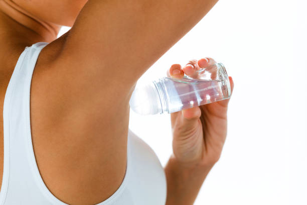 istock Beautiful young woman using deodorant over white background. 1059166170