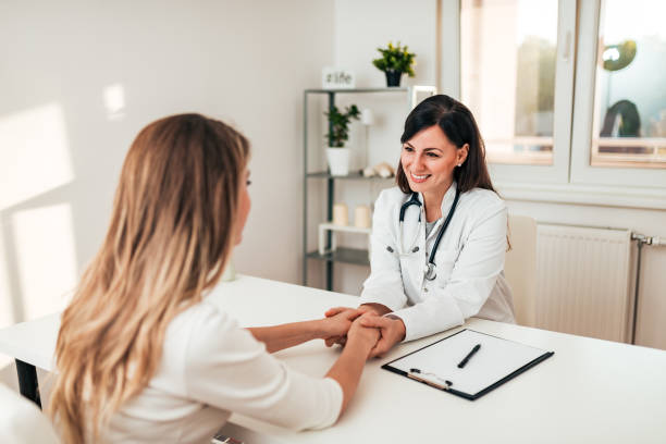 istock Smiling doctor reassuring her female patient. 1059169912