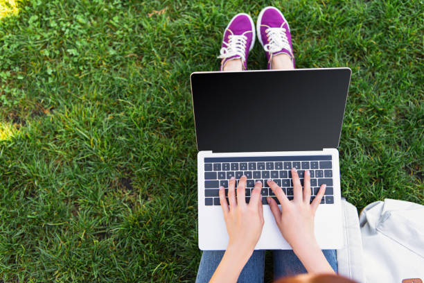 istock cropped image of freelancer using laptop with blank screen in park 1059170616