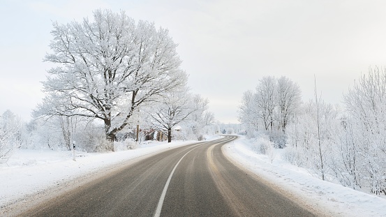 S-shape rural road through a winter wonderland with rime