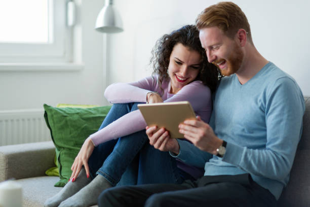 istock Young couple using digital tablet at home 1059177426