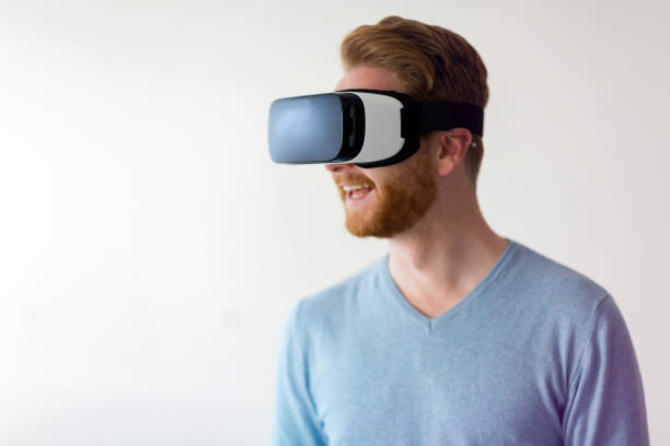 istock Man wearing virtual reality headset at home 1059177442